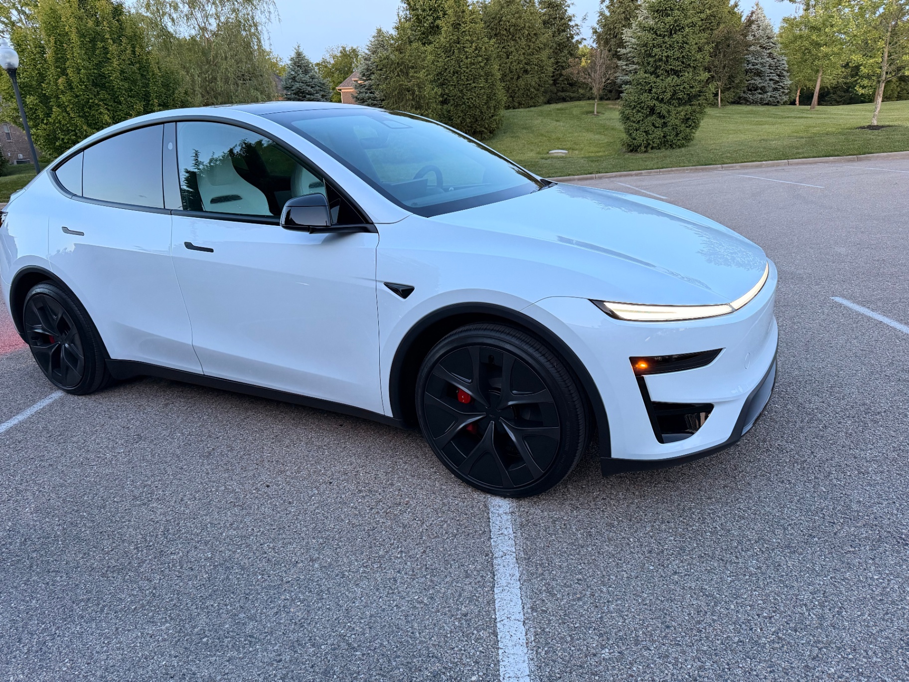 White Tesla Model Y Performance owned by Lynne Lawson parked at dusk in Ohio